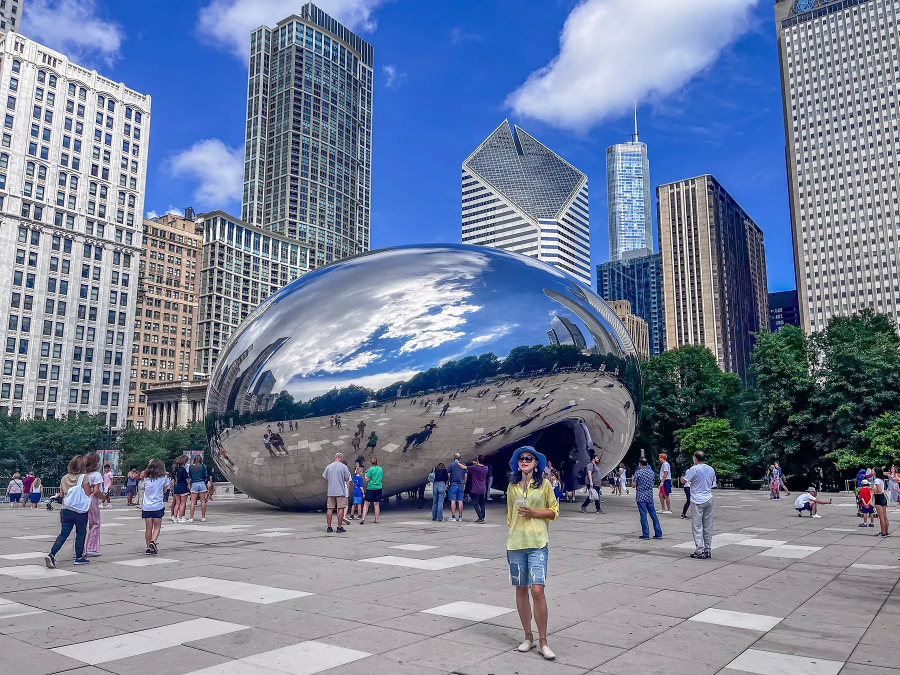 Cloud Gate in Millennium Park with the Chicago skyline behind it